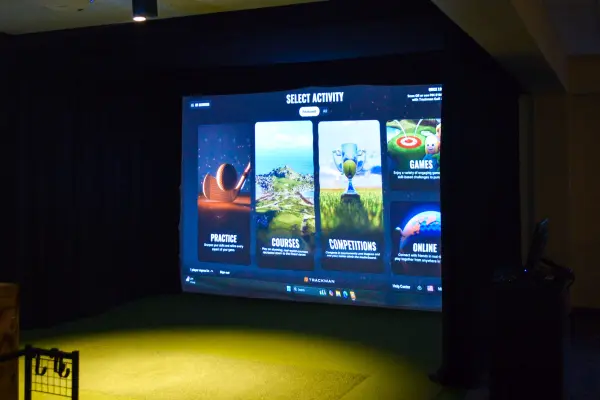Golf simulator with various activity options displayed.