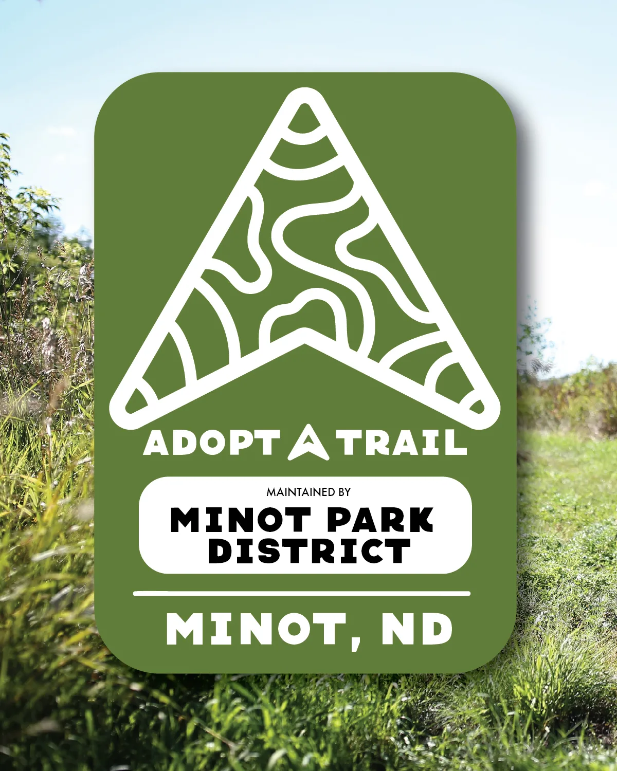 Image of an Adopt A Trail sign in a park setting.